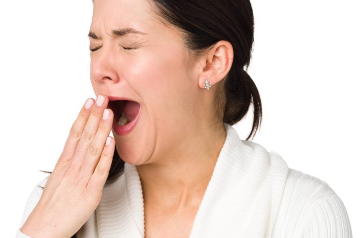 woman with sleep apnea yawning