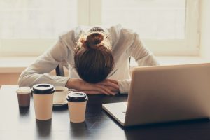 Sleep-deprived woman at desk