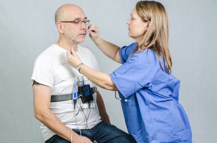 Man being prepped by female doctor for Sleep Study