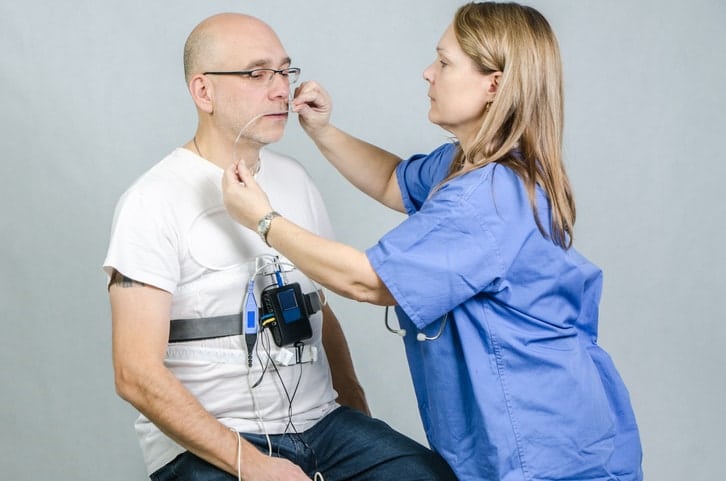 Man being prepped by female doctor for Sleep Study